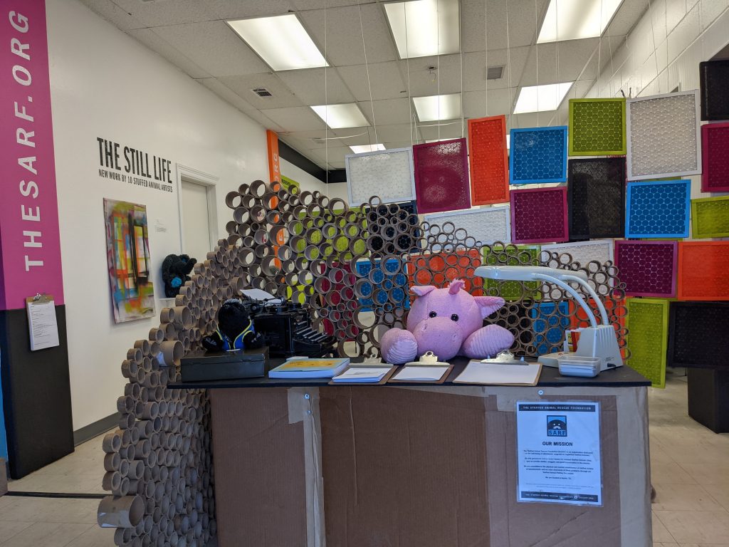 Stuffed animal working at the reception desk.