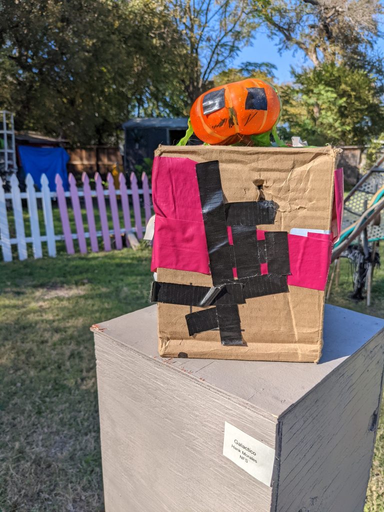 Mixed-media art. Pumpkin on a box with tape.