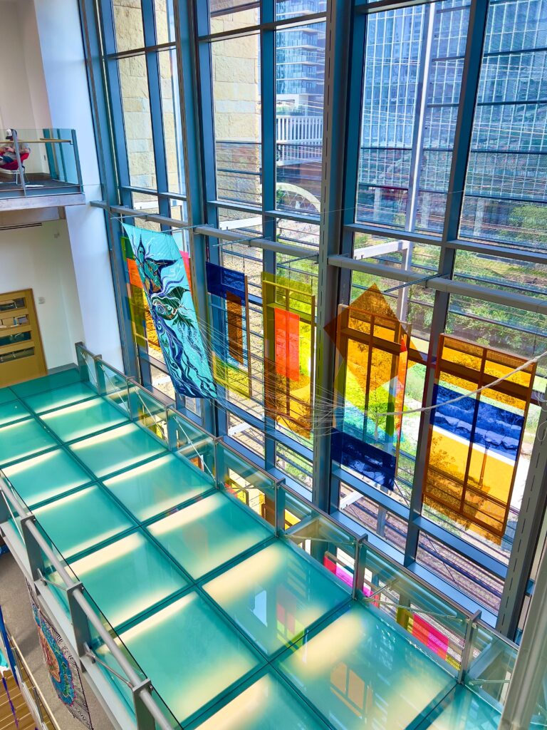Inside the glass wall of the Austin Downtown Library
